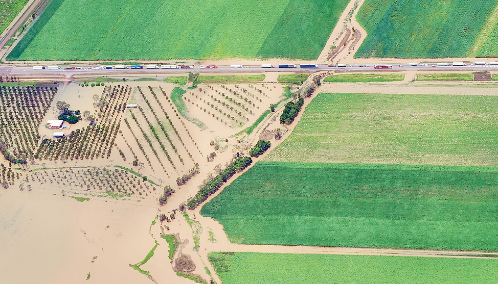 Aerial photograph of fields and a road showing traffic