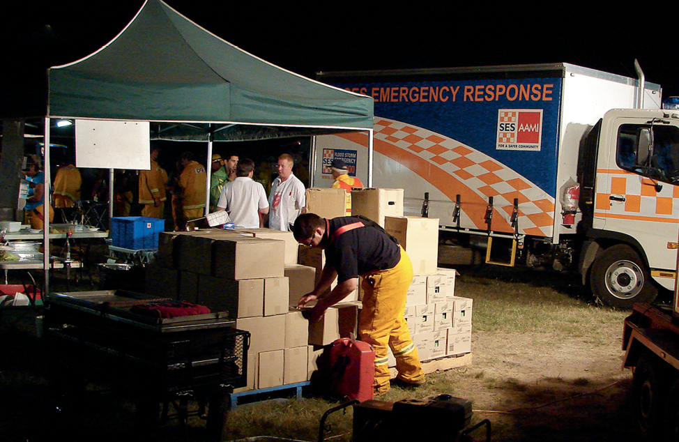 Emergency response volunteers gather at a supply stall.