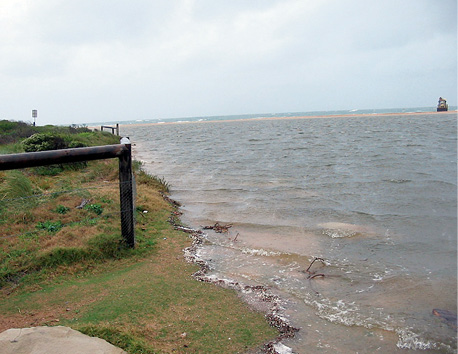 Photograph of the ocean meeting land.