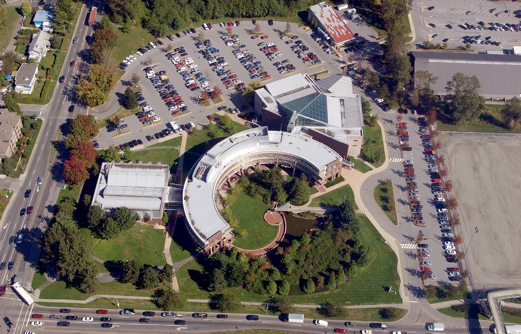Aerial photograph of The Justice Institute of
British Columbia in Canada. It is a semicircular building surrounded by trees and carparks.
