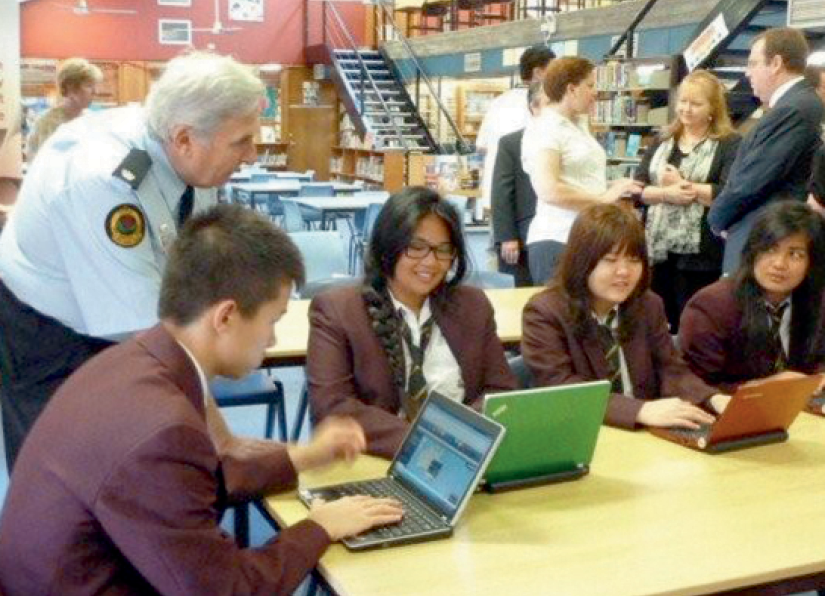 Photograph of students using laptops in a library