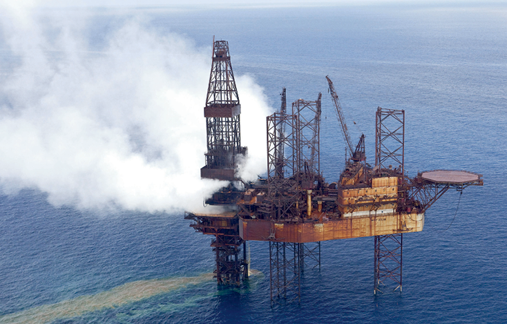 Photograph of an offshore structure billowing smoke