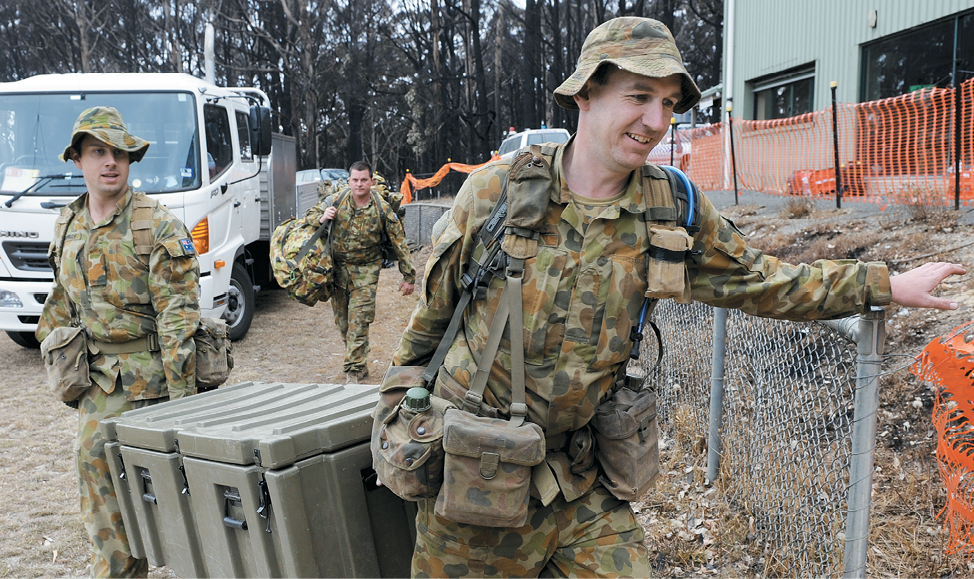 Photograph of ADF staff in uniforms carrying crates and bags