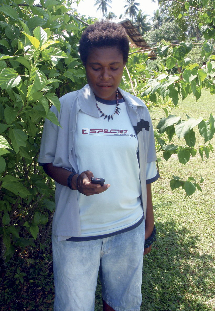 Photograph of Christine Yass looking at her mobile phone