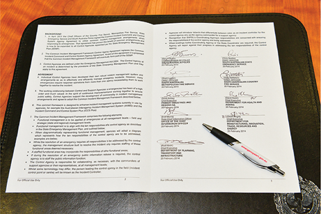 The agreement’s signature page with a pen.