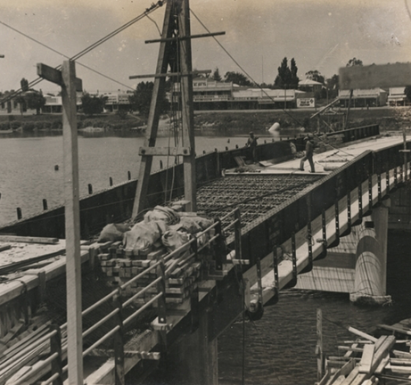 A vintage sepia-toned photograph of a bridge being repaired.