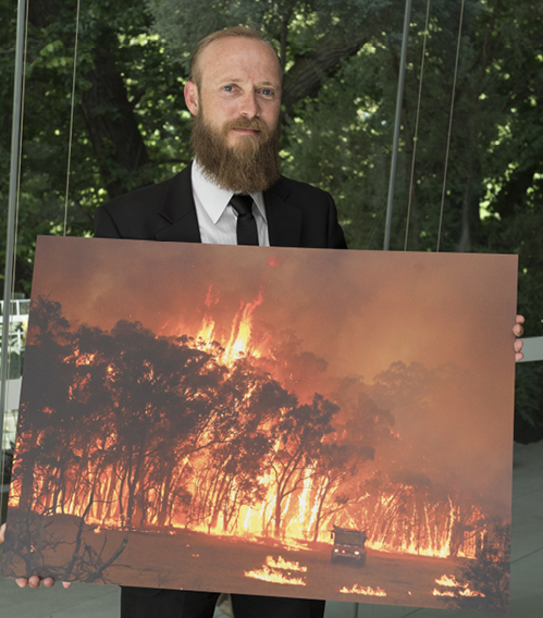 A photo of Glenn Daniels, Bendigo Advertiser, with his photo ‘Fire rages’, which was a finalist in the 2016 Resilient Australia National Photography Award. His photo shows a forest ablaze in Kyneton, Victoria.