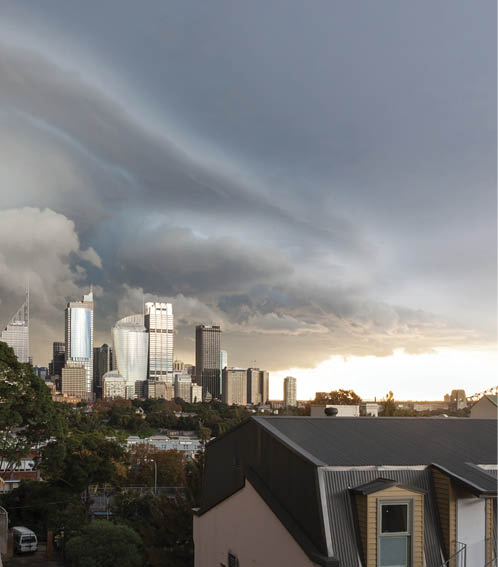 A photo of a stormy sky, with clouds moving over a city.