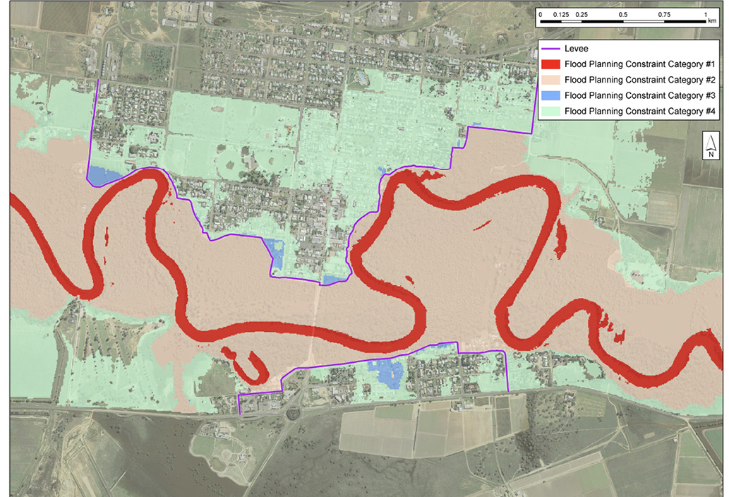 Figure 1: An aerial view of an area of about 4 kilometres by 3 kilometres, showing flood planning constraint categories for a floodplain adjacent to a river. Four flood planning constraint categories are shown in different colours: 1 (nearest the river) 2, 3 and 4 (furthest from the river). A levee is also shown.