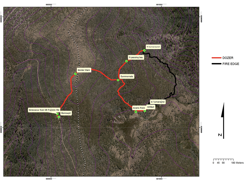 Aerial photo of bushland showing key features of the site of the Ginini fire. Coloured lines are used to show the fire edge and the route taken by bulldozers.