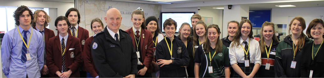 Image of the students standing alongside Craig Lapsley and Mary-Anne Thomas.